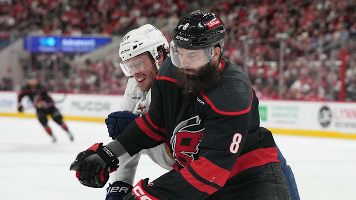 May 22, 2025; Raleigh, North Carolina, USA;  Carolina Hurricanes defenseman Brent Burns (8) defends against Florida Panthers forward Carter Verhaeghe (23) during the second period in game two of the Eastern Conference Final of the 2025 Stanley Cup Playoffs at Lenovo Center. Mandatory Credit: James Guillory-Imagn Images