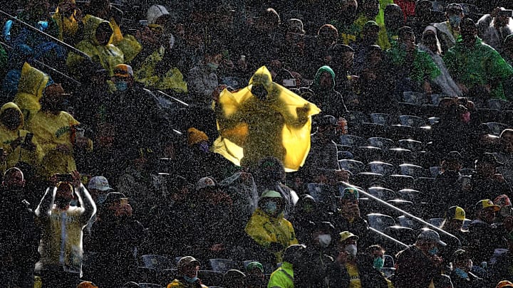After a downpour, the sun shines through a fan’s rain cover during the first quarter Autzen Stadium during the Oregon vs. Stony Brook game in 2021.