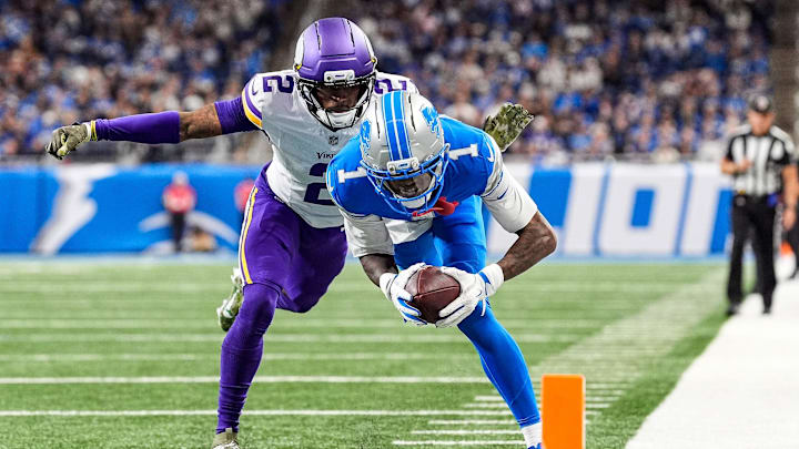 Detroit Lions wide receiver Jameson Williams (1) dives for a touchdown against Minnesota Vikings cornerback Isaiah Rodgers (2) during the second half at Ford Field in Detroit on Sunday, November 2, 2025.