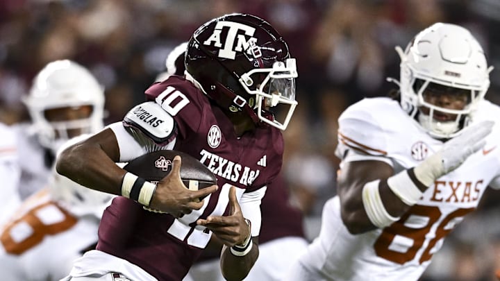 Nov 30, 2024; College Station, Texas, USA; Texas A&M Aggies quarterback Marcel Reed (10) runs the ball during the first half against the Texas Longhorns. The Longhorns defeated the Aggies 17-7 at Kyle Field. Mandatory Credit: Maria Lysaker-Imagn Images  