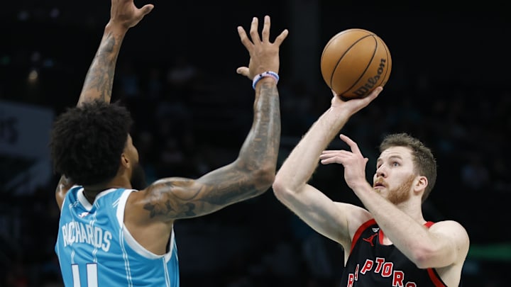 Apr 4, 2023; Charlotte, North Carolina, USA; Toronto Raptors center Jakob Poeltl (19) shoots against Charlotte Hornets center Nick Richards (4) during the first half at Spectrum Center. Mandatory Credit: Nell Redmond-Imagn Images Apr 4, 2023; Charlotte, North Carolina, USA; Toronto Raptors center Jakob Poeltl (19) shoots against Charlotte Hornets center Nick Richards (4) during the first half at Spectrum Center. Mandatory Credit: Nell Redmond-Imagn Images