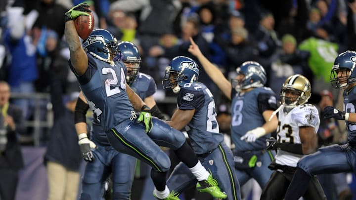 Jan 8, 2011; Seattle, WA, USA; Seattle Seahawks running back Marshawn Lynch (24) leaps into the end zone to score on a 67-yard touchdown run in the fourth quarter of the NFC Wild Card playoff game against the New Orleans Saints at Qwest Field. Mandatory Credit: Kirby Lee/Image of Sport-Imagn Images Jan 8, 2011; Seattle, WA, USA; Seattle Seahawks running back Marshawn Lynch (24) leaps into the end zone to score on a 67-yard touchdown run in the fourth quarter of the NFC Wild Card playoff game against the New Orleans Saints at Qwest Field. Mandatory Credit: Kirby Lee/Image of Sport-Imagn Images