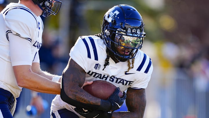 Oct 26, 2024; Laramie, Wyoming, USA; Utah State Aggies running back Rahsul Faison (3) warms up before the game against the Wyoming Cowboys at Jonah Field at War Memorial Stadium. Mandatory Credit: Troy Babbitt-Imagn Images