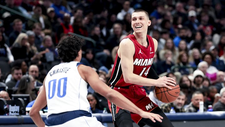 Feb 13, 2025; Dallas, Texas, USA; Miami Heat guard Tyler Herro (14) controls the ball as Dallas Mavericks guard Max Christie (00) defends during the second half at American Airlines Center. Mandatory Credit: Kevin Jairaj-Imagn Images