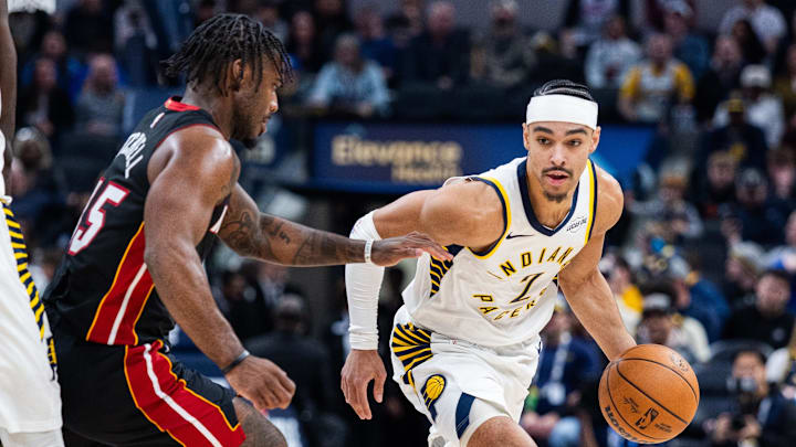 Jan 10, 2026; Indianapolis, Indiana, USA;  Indiana Pacers guard/forward Andrew Nembhard (2) dribbles the ball while  Miami Heat guard Davion Mitchell (45) defends in the first half at Gainbridge Fieldhouse. Mandatory Credit: Trevor Ruszkowski-Imagn Images