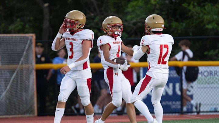 September 14, 2023; Mount Olive HS Jekori Zapata (4) celebrates his touchdown with teammates Lincoln Youtz (3) and Vincent Carpini (12) against Morristown HS in Morristown, New Jersey, USA; Morristown High School. Mandatory Credit: Tom Salus-The Record