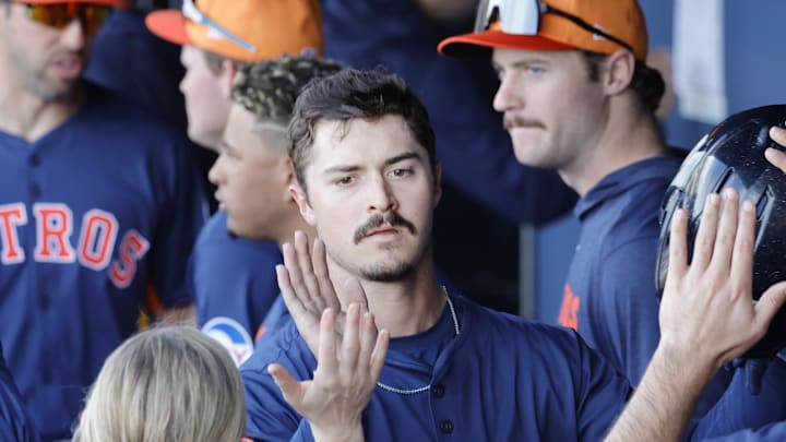 After scoring Houston Astros outfielder Colin Barber is congratulated by teammates in the dugout in the eighth inning against the Washington Nationals at CACTI Park of the Palm Beaches in West Palm Beach, Fla., on Feb. 22, 2025.