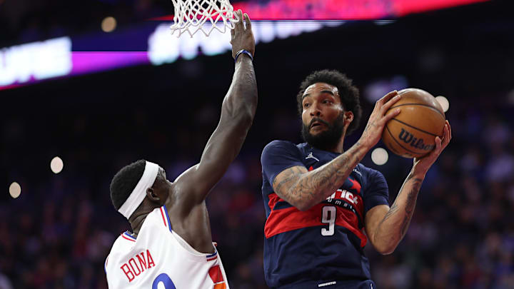 Mar 26, 2025; Philadelphia, Pennsylvania, USA; Washington Wizards forward Justin Champagnie (9) drives against Philadelphia 76ers center Adem Bona (30) during the second quarter at Wells Fargo Center. Mandatory Credit: Bill Streicher-Imagn Images