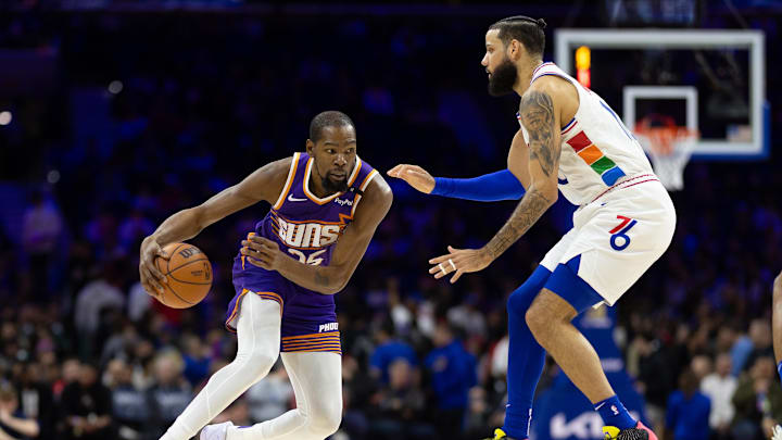 Jan 6, 2025; Philadelphia, Pennsylvania, USA; Phoenix Suns forward Kevin Durant (35) dribbles the ball against Philadelphia 76ers forward Caleb Martin (16) during the third quarter at Wells Fargo Center. Mandatory Credit: Bill Streicher-Imagn Images