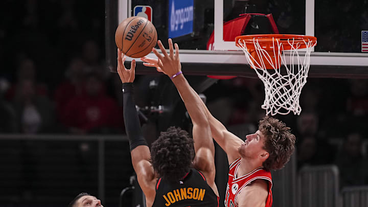 Dec 21, 2025; Atlanta, Georgia, USA; Chicago Bulls forward Matas Buzelis (14) defends a shot by Atlanta Hawks forward Jalen Johnson (1) during the second half at State Farm Arena. Mandatory Credit: Dale Zanine-Imagn Images