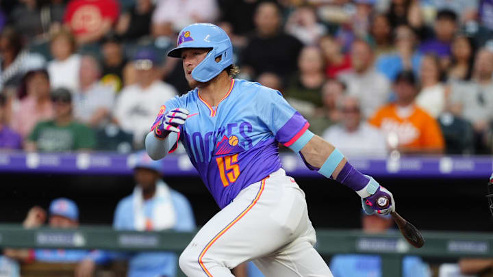 Jun 20, 2025; Denver, Colorado, USA; Colorado Rockies catcher Hunter Goodman (15) hits a two run double in the fourth inning against the Arizona Diamondbacks at Coors Field. 