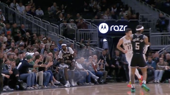 Bucks forward Portis steps on a drink after making a basket