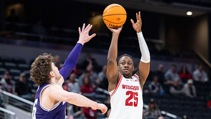 Mar 13, 2025; Indianapolis, IN, USA; Wisconsin Badgers guard John Blackwell (25) shoots the ball while Northwestern Wildcats forward Nick Martinelli (2) defends in the second half at Gainbridge Fieldhouse.
