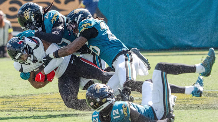 Jacksonville Jaguars safety Eric Murray (29) and Jacksonville Jaguars safety Antonio Johnson (26) tackles Houston Texans wide receiver Christian Kirk (13) during the fourth quarter between the Houston Texans and the Jacksonville Jaguars Sunday September 21, 2025 at EverBank Stadium in Jacksonville, Fla. The Jaguars defeated the Texans 17-10. [Doug Engle/Florida Times-Union]