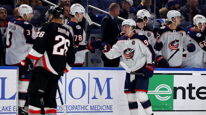 Feb 4, 2025; Buffalo, New York, USA;  Columbus Blue Jackets center Kent Johnson (91) celebrates his goal with teammates during the second period against the Buffalo Sabres at KeyBank Center. Mandatory Credit: Timothy T. Ludwig-Imagn Images