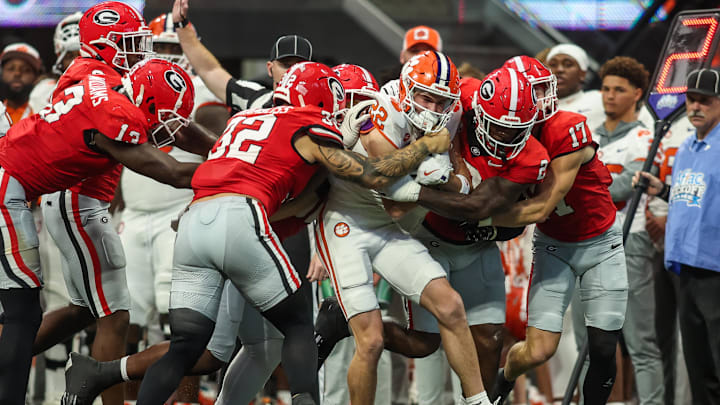 Aug 31, 2024; Atlanta, Georgia, USA; Clemson Tigers wide receiver Cole Turner (22) is tackled by Georgia Bulldogs linebacker Chaz Chambliss (32) and linebacker Smael Mondon Jr. (2) in the third quarter at Mercedes-Benz Stadium. Mandatory Credit: Brett Davis-Imagn Images