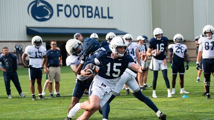 Penn State quarterback Drew Allar runs with the ball during practice outside Holuba Hall. Penn State quarterback Drew Allar runs with the ball during practice outside Holuba Hall.