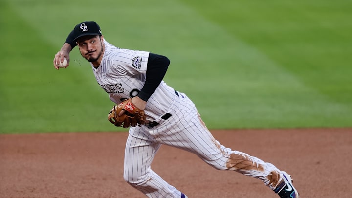 Colorado Rockies third baseman Nolan Arenado (28) fields and throws to first base in the first inning against the Los Angeles Angels at Coors Field in 2020.