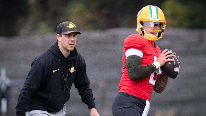 Oregon quarterback Dillon Gabriel throws out a pass as offensive coordinator Will Stein during practice with the Oregon Ducks on Tuesday, Aug. 27, 2024, at the Hatfield-Dowlin Complex in Eugene, Ore.
