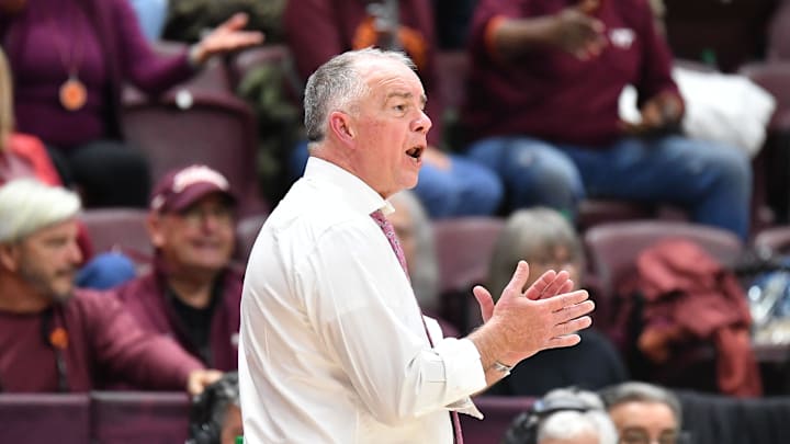 Feb 14, 2026; Blacksburg, Virginia, USA;  Virginia Tech Hokies head coach Mike Young cheers for his team during the second half at Coliseum. Mandatory Credit: Brian Bishop-Imagn Images