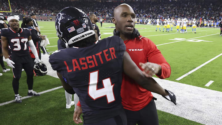 Jan 11, 2025; Houston, Texas, USA; Houston Texans head coach DeMeco Ryans embraces cornerback Kamari Lassiter (4) after a play during the game against the Los Angeles Chargers in an AFC wild card game at NRG Stadium. Mandatory Credit: Troy Taormina-Imagn Images