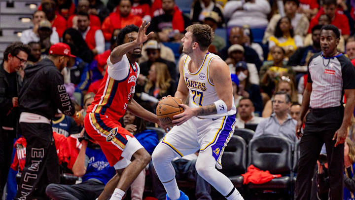 Nov 14, 2025; New Orleans, Louisiana, USA;  Los Angeles Lakers forward/guard Luka Dončić (77) dribbles against New Orleans Pelicans forward Herbert Jones (2) during the second half at Smoothie King Center. Mandatory Credit: Stephen Lew-Imagn Images