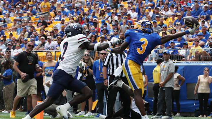 Aug 30, 2025; Pittsburgh, Pennsylvania, USA; Pittsburgh Panthers wide receiver Cataurus Hicks (3) catches a touchdown pass behind Duquesne Dukes defensive back DJ Cerisier (2) during the second quarter at Acrisure Stadium. Mandatory Credit: Charles LeClaire-Imagn Images