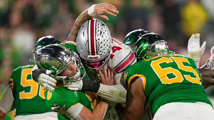 Ohio State defensive end JT Tuimoloau (44) hits Oregon quarterback Dillon Gabriel during the second half of the College Football Playoff quarterfinal at the Rose Bowl in Pasadena, Calif. on Jan. 1, 2025. Ohio State defensive end JT Tuimoloau (44) hits Oregon quarterback Dillon Gabriel during the second half of the College Football Playoff quarterfinal at the Rose Bowl in Pasadena, Calif. on Jan. 1, 2025.