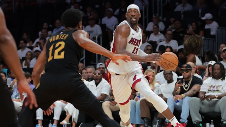 Apr 26, 2025; Miami, Florida, USA; Miami Heat center Bam Adebayo (13) drives to the basket against Cleveland Cavaliers forward De'Andre Hunter (12) in the third quarter during game three for the first round of the 2025 NBA Playoffs at Kaseya Center. Mandatory Credit: Sam Navarro-Imagn Images