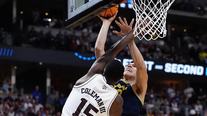 Mar 22, 2025; Denver, CO, USA; Michigan Wolverines center Vladislav Goldin (50) attempts to shoot the ball against Texas A&M Aggies forward Henry Coleman III (15) during the second half in the second round of the NCAA Tournament  at Ball Arena. Mandatory Credit: Ron Chenoy-Imagn Images
