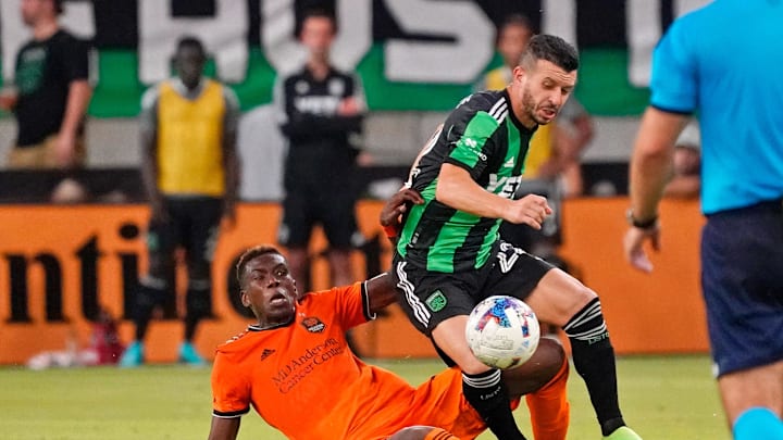 Jul 12, 2022; Austin, Texas, USA; Houston Dynamo defender Teenage Hadebe (17) slide tackles Austin