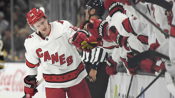 Apr 9, 2024; Boston, Massachusetts, USA; Carolina Hurricanes center Jake Guentzel (59) is congratulated by his teammates after scoring a goal during the third period against the Boston Bruins at TD Garden. Mandatory Credit: Bob DeChiara-Imagn Images