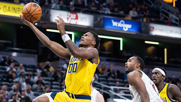 Dec 1, 2025; Indianapolis, Indiana, USA;  Indiana Pacers guard Bennedict Mathurin (00) shoots the ball while Cleveland Cavaliers center Evan Mobley (4) defends in the second half at Gainbridge Fieldhouse. Mandatory Credit: Trevor Ruszkowski-Imagn Images
