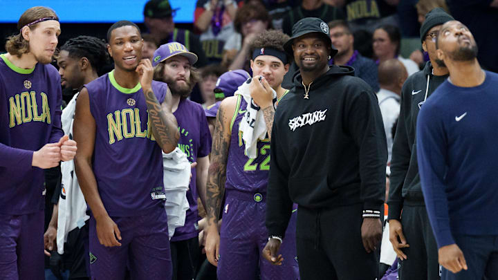 Mar 30, 2025; New Orleans, Louisiana, USA; New Orleans Pelicans forward Zion Williamson, wearing street clothes and hat, smiles as his team gains a lead late during the fourth quarter against the Charlotte Hornets at Smoothie King Center. Mandatory Credit: Matthew Hinton-Imagn Images Mar 30, 2025; New Orleans, Louisiana, USA; New Orleans Pelicans forward Zion Williamson, wearing street clothes and hat, smiles as his team gains a lead late during the fourth quarter against the Charlotte Hornets at Smoothie King Center. Mandatory Credit: Matthew Hinton-Imagn Images