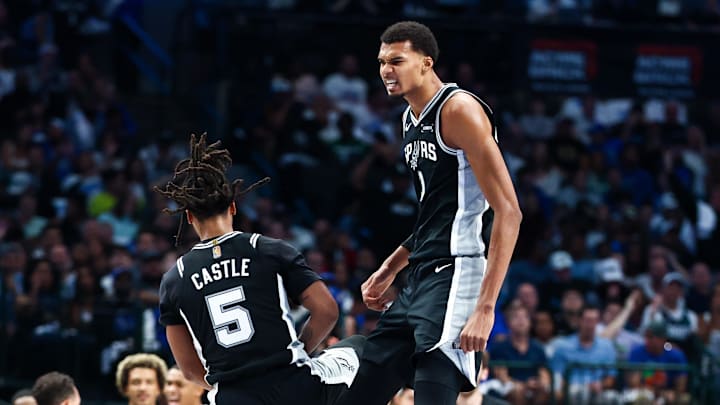 Oct 22, 2025; Dallas, Texas, USA;   San Antonio Spurs forward Victor Wembanyama (1) celebrates with San Antonio Spurs guard Stephon Castle (5) during the first half  against the Dallas Mavericks at American Airlines Center. Mandatory Credit: Kevin Jairaj-Imagn Images