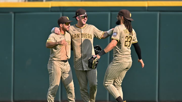 Sep 21, 2025; Chicago, Illinois, USA; San Diego Padres left fielder Ramon Laureano (5), center fielder Jackson Merrill (3), and right fielder Fernando Tatis Jr. (23) celebrate after defeating the Chicago White Sox at Rate Field. 