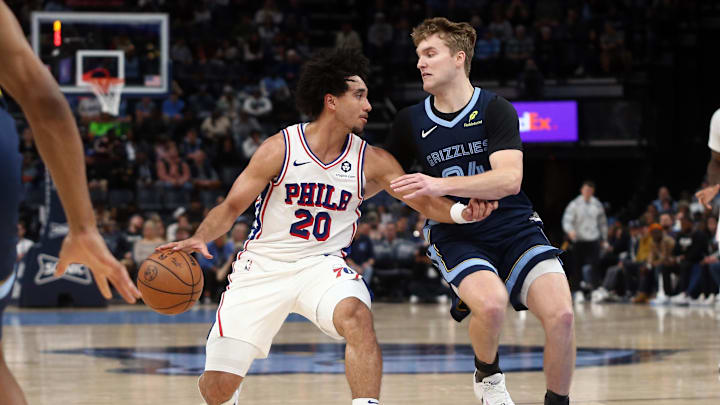 Nov 20, 2024; Memphis, Tennessee, USA; Philadelphia 76ers guard Jared McCain (20) dribbles as Memphis Grizzlies guard Cam Spencer (24) defends during the first half at FedExForum. Mandatory Credit: Petre Thomas-Imagn Images