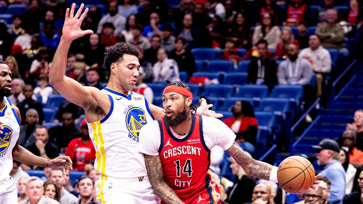 Nov 22, 2024; New Orleans, Louisiana, USA;  New Orleans Pelicans forward Brandon Ingram (14) dribbles against Golden State Warriors forward Trayce Jackson-Davis (32) during first half at Smoothie King Center. Mandatory Credit: Stephen Lew-Imagn Images