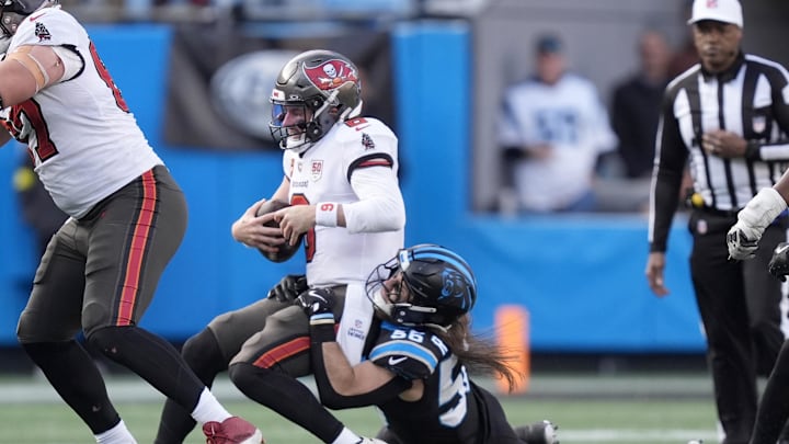Dec 21, 2025; Charlotte, North Carolina, USA; Carolina Panthers linebacker Christian Rozeboom (56) tackles Tampa Bay Buccaneers quarterback Baker Mayfield (6) during the second half at Bank of America Stadium. Mandatory Credit: Jim Dedmon-Imagn Images
