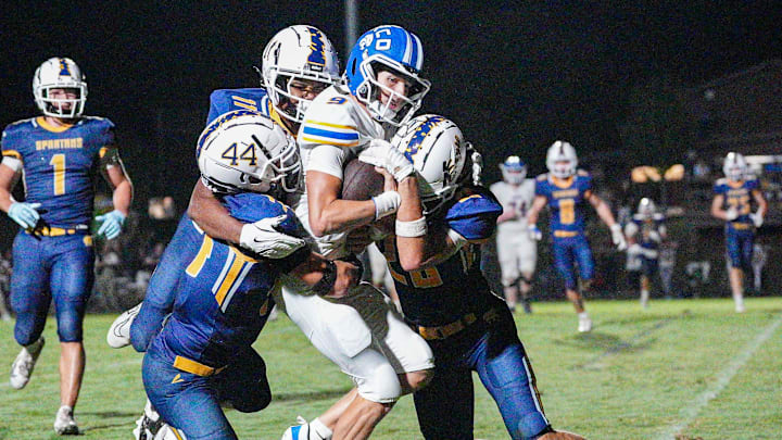 Sayre's Jordan Backers (44) and AJ Corrigan (26) couldn't stop KCD quarterback Caden Long (9) from scoring one of his four touchdowns. The Bearcats defeated the defending 2024 Class A state champ Spartans 31-28 in Lexington, Kentucky during the KHSAA Class A high school football season opener. August 22, 2025