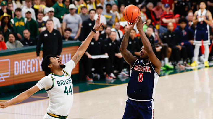 Feb 24, 2026; Waco, Texas, USA;  Arizona Wildcats guard Jaden Bradley (0) scores a basket against Baylor Bears center Caden Powell (44) during the first half at Paul and Alejandra Foster Pavilion. Mandatory Credit: Chris Jones-Imagn Images