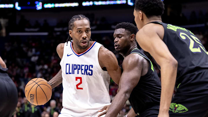 LA Clippers forward Kawhi Leonard (2) dribbles against New Orleans Pelicans forward Zion Williamson (1) and guard Trey Murphy III (25) during the second half at Smoothie King Center. Mandatory Credit: Stephen Lew-Imagn Images