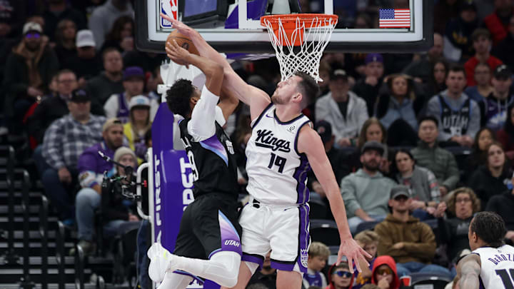 Nov 28, 2025; Salt Lake City, Utah, USA; Sacramento Kings guard Russell Westbrook (18) blocks the shot of Utah Jazz guard Ace Bailey (19) during the first quarter at Delta Center. Mandatory Credit: Chris Nicoll-Imagn Images