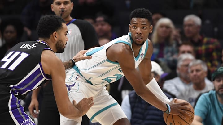 Jan 10, 2024; Charlotte, North Carolina, USA; Charlotte Hornets forward Brandon Miller (24) looks to pass as he is defended by Sacramento Kings forward Trey Lyles (41) during the first half at the Spectrum Center. Mandatory Credit: Sam Sharpe-Imagn Images