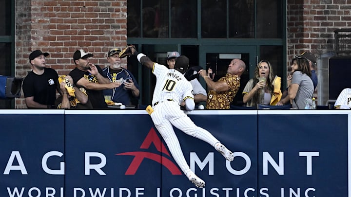 Oct 8, 2024; San Diego, California, USA; San Diego Padres outfielder Jurickson Profar (10) attempts to make a catch on a home run hit by Los Angeles Dodgers shortstop Mookie Betts (not pictured) in the first inning during game three of the NLDS for the 2024 MLB Playoffs at Petco Park. Mandatory Credit: Denis Poroy-Imagn Images Oct 8, 2024; San Diego, California, USA; San Diego Padres outfielder Jurickson Profar (10) attempts to make a catch on a home run hit by Los Angeles Dodgers shortstop Mookie Betts (not pictured) in the first inning during game three of the NLDS for the 2024 MLB Playoffs at Petco Park. Mandatory Credit: Denis Poroy-Imagn Images