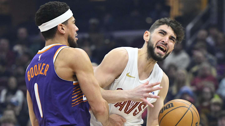 Jan 20, 2025; Cleveland, Ohio, USA; Phoenix Suns guard Devin Booker (1) defends Cleveland Cavaliers guard Ty Jerome (2) in the first quarter at Rocket Mortgage FieldHouse. Mandatory Credit: David Richard-Imagn Images