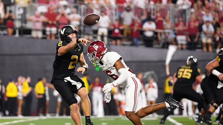 Oct 5, 2024; Nashville, Tennessee, USA;  Vanderbilt Commodores quarterback Diego Pavia (2) scrambles as Alabama Crimson Tide defensive back Red Morgan (16) bears down on him during the second half at FirstBank Stadium. Mandatory Credit: Steve Roberts-Imagn Images