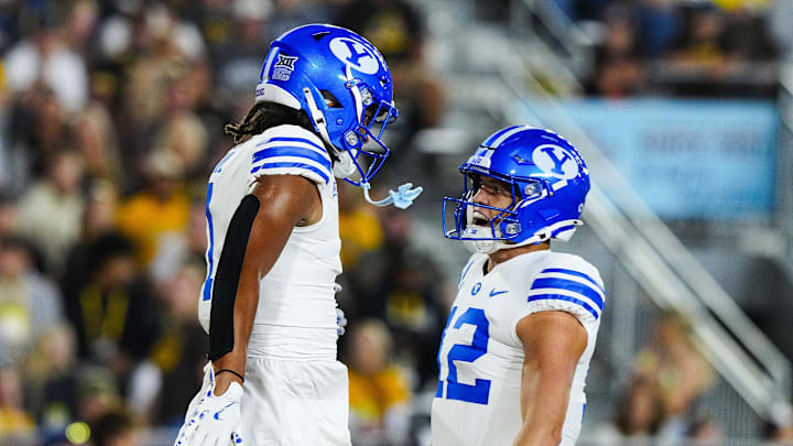 Sep 14, 2024; Laramie, Wyoming, USA; Brigham Young Cougars tight end Keanu Hill (1) celebrates a touchdown with quarterback Jake Retzlaff (12) against the Wyoming Cowboys during the first quarter at Jonah Field at War Memorial Stadium.