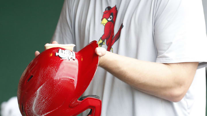 Jul 3, 2024; Pittsburgh, Pennsylvania, USA;  A St. Louis Cardinals equipment manager shines the batting helmets prior to a game against the Pittsburgh Pirates at PNC Park. Mandatory Credit: Charles LeClaire-Imagn Images