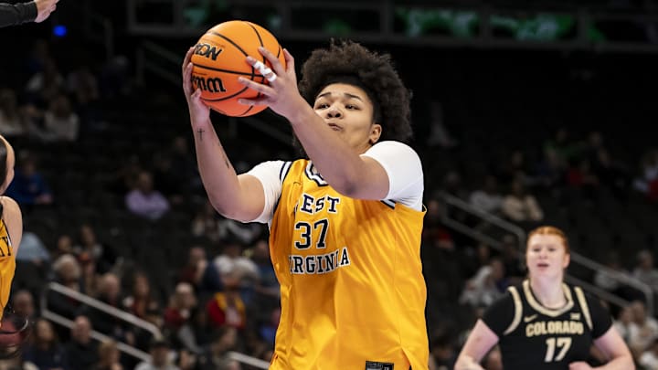 Mar 7, 2026; Kansas City, MO, USA;  West Virginia forward Celia Riviere (37) brings down a rebound against the Colorado Buffaloes during the first half at T-Mobile Center. Mandatory Credit: Nick Tre. Smith-Imagn Images